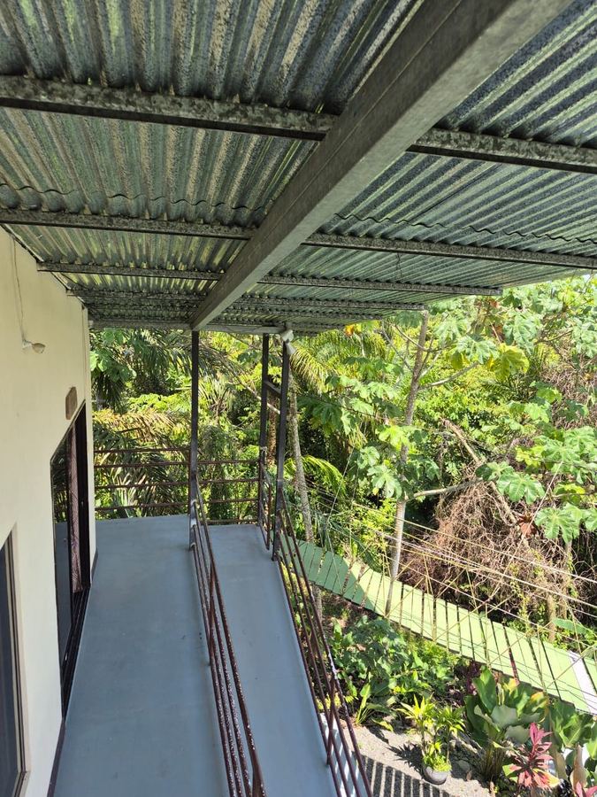 Balcón elevado de la Casa Familiar Segundo Piso, con vista al dosel de la selva y al puente de canopy